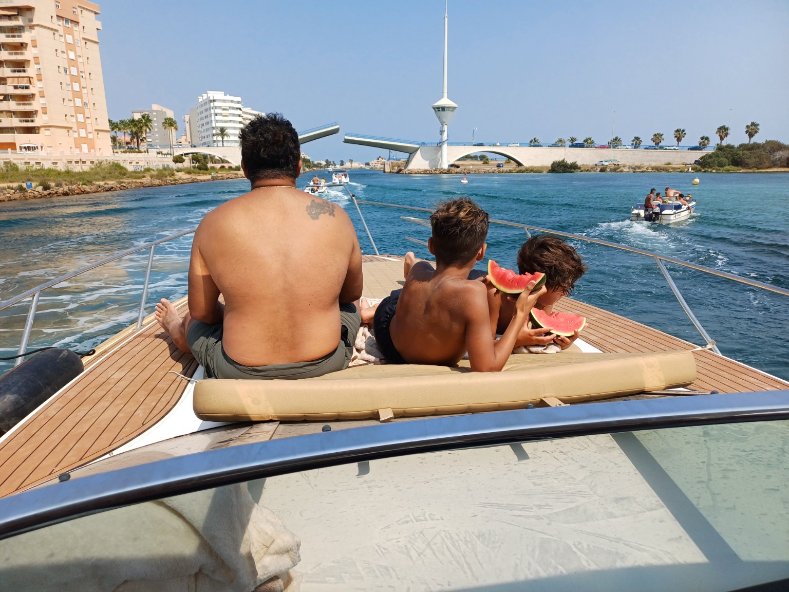 A family enjoying the boat and sharing watermelon