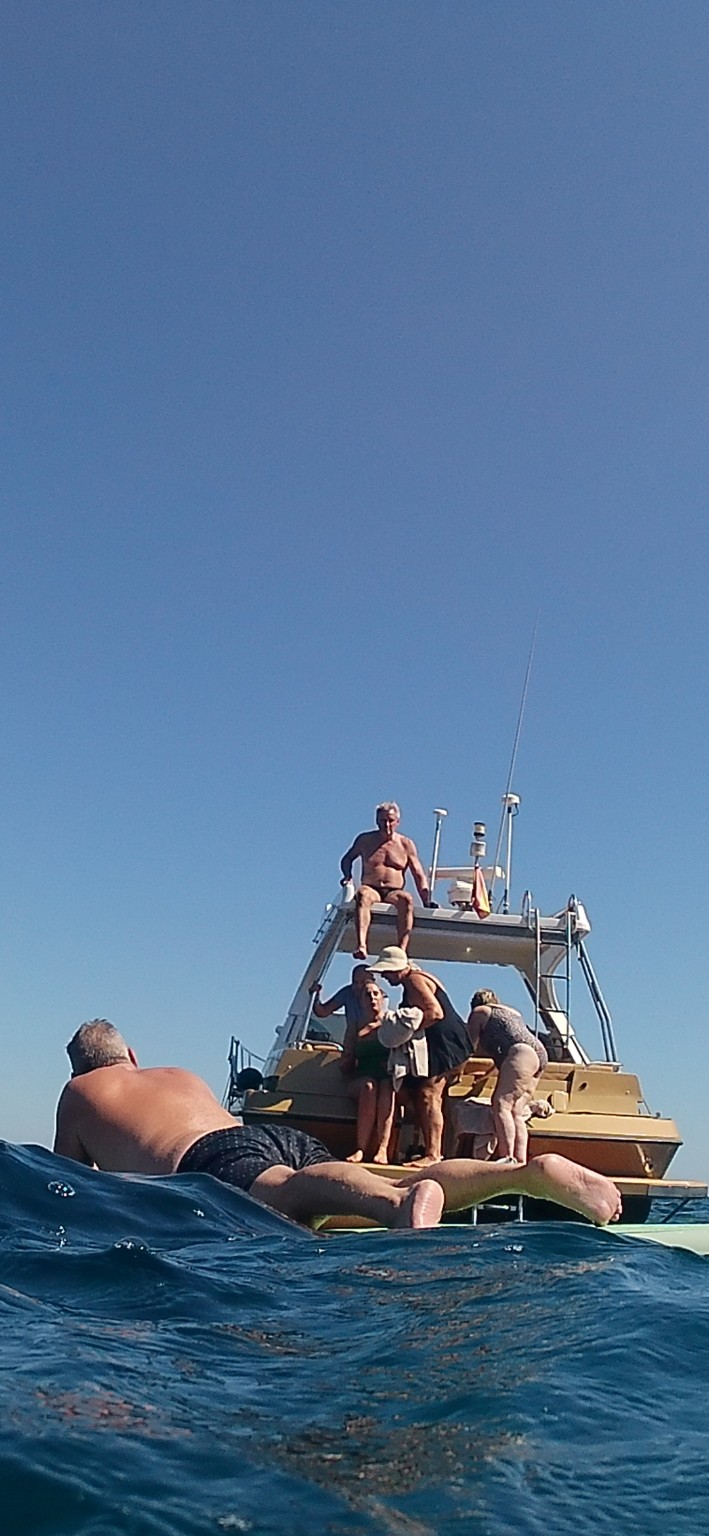 Guests enjoying a swim beside the yacht