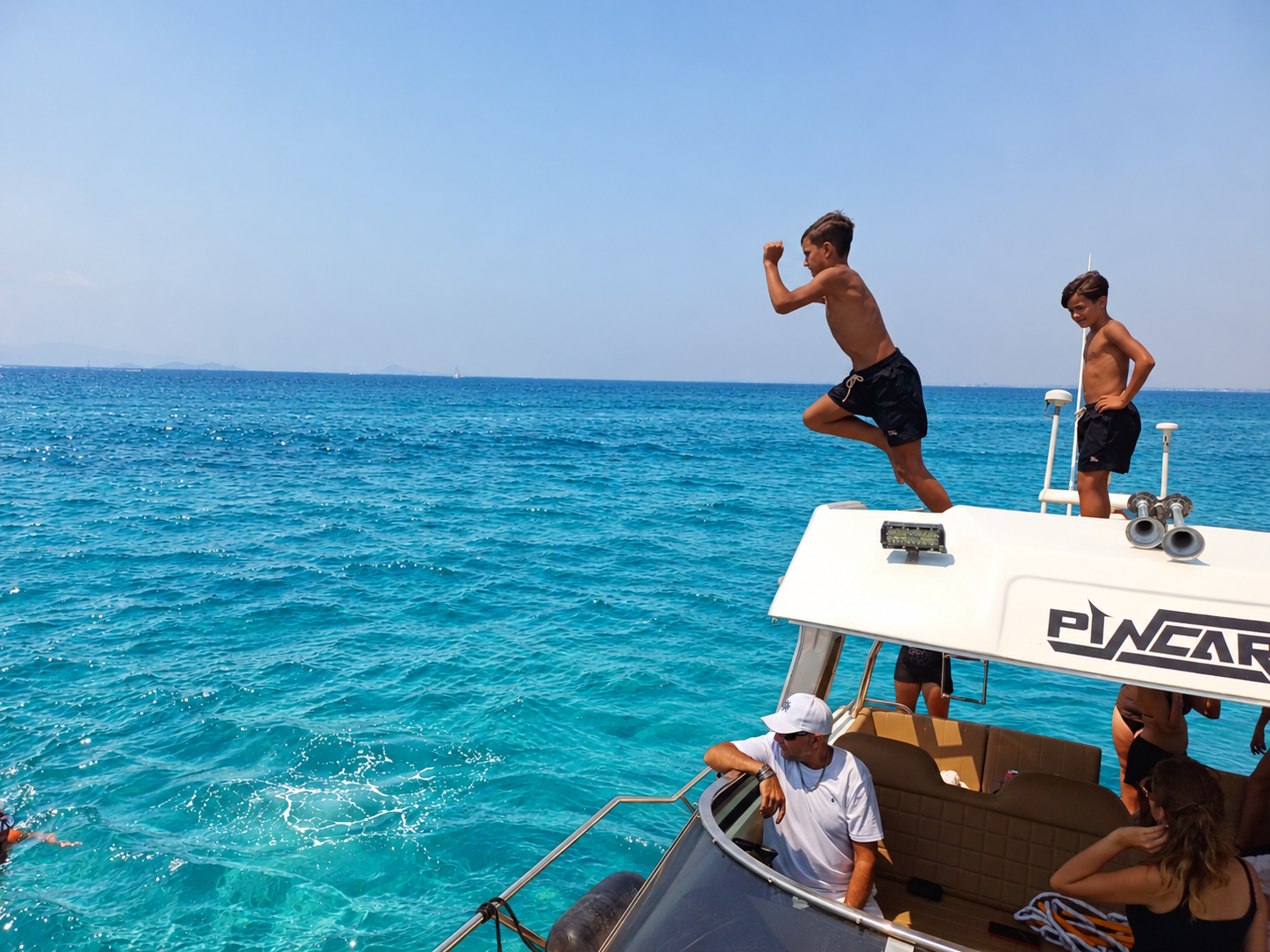 Guest jumping into turquoise water from the Sunseeker Martinique